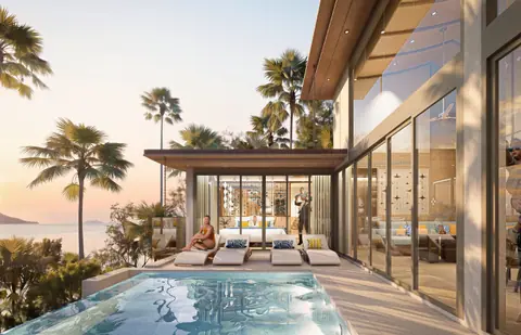 Villa pool and palms glowing gold as the sun sets over the sea