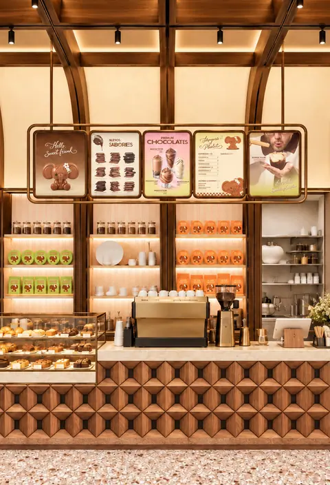 Chocolate Atelier counter with shelves of chocolates and menu boards