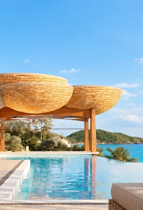Sky Pool beneath woven umbrella shades, with the Andaman Sea beyond