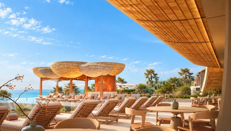 Sky Pool loungers beneath woven umbrella shades